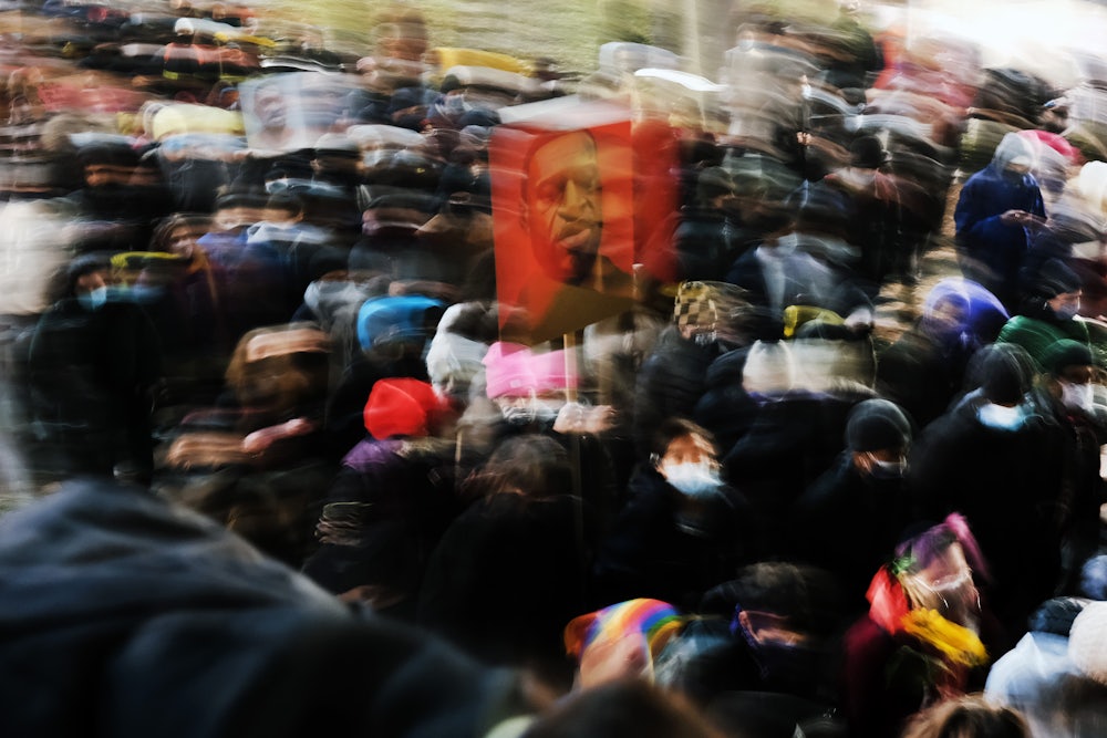 People gather in a Manhattan park to protest on the first day of the trial for the killing of George Floyd.
