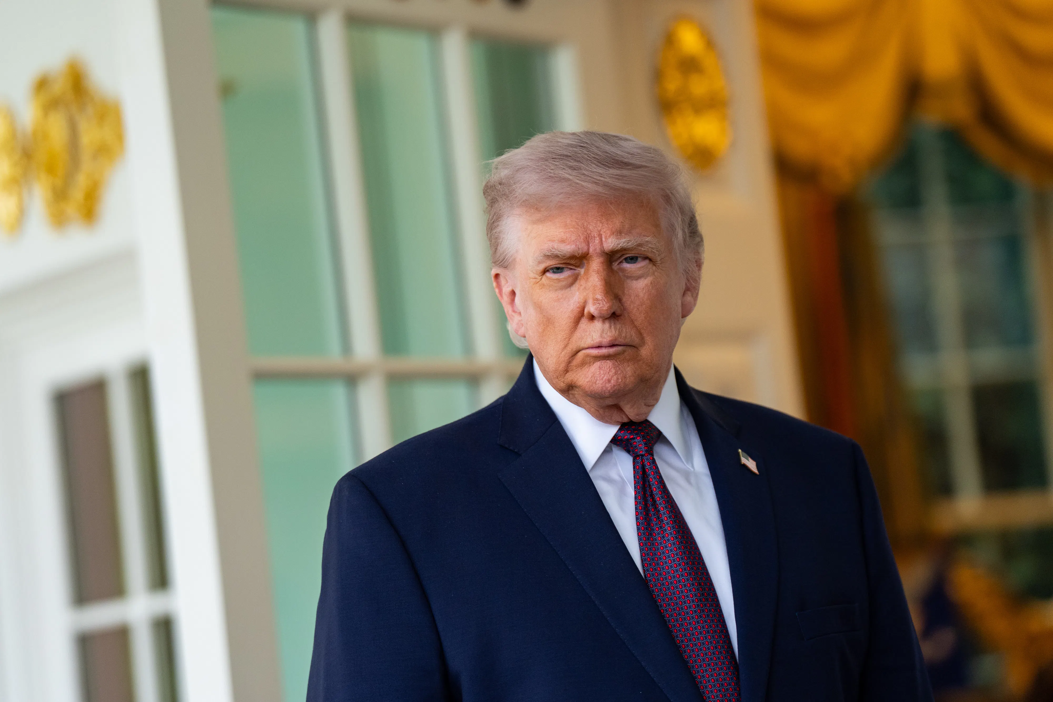 Donald Trump frowns while standing outside the Oval Office