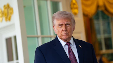 Donald Trump frowns while standing outside the Oval Office