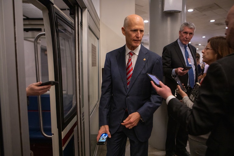 Rick Scott speaking to reporters
