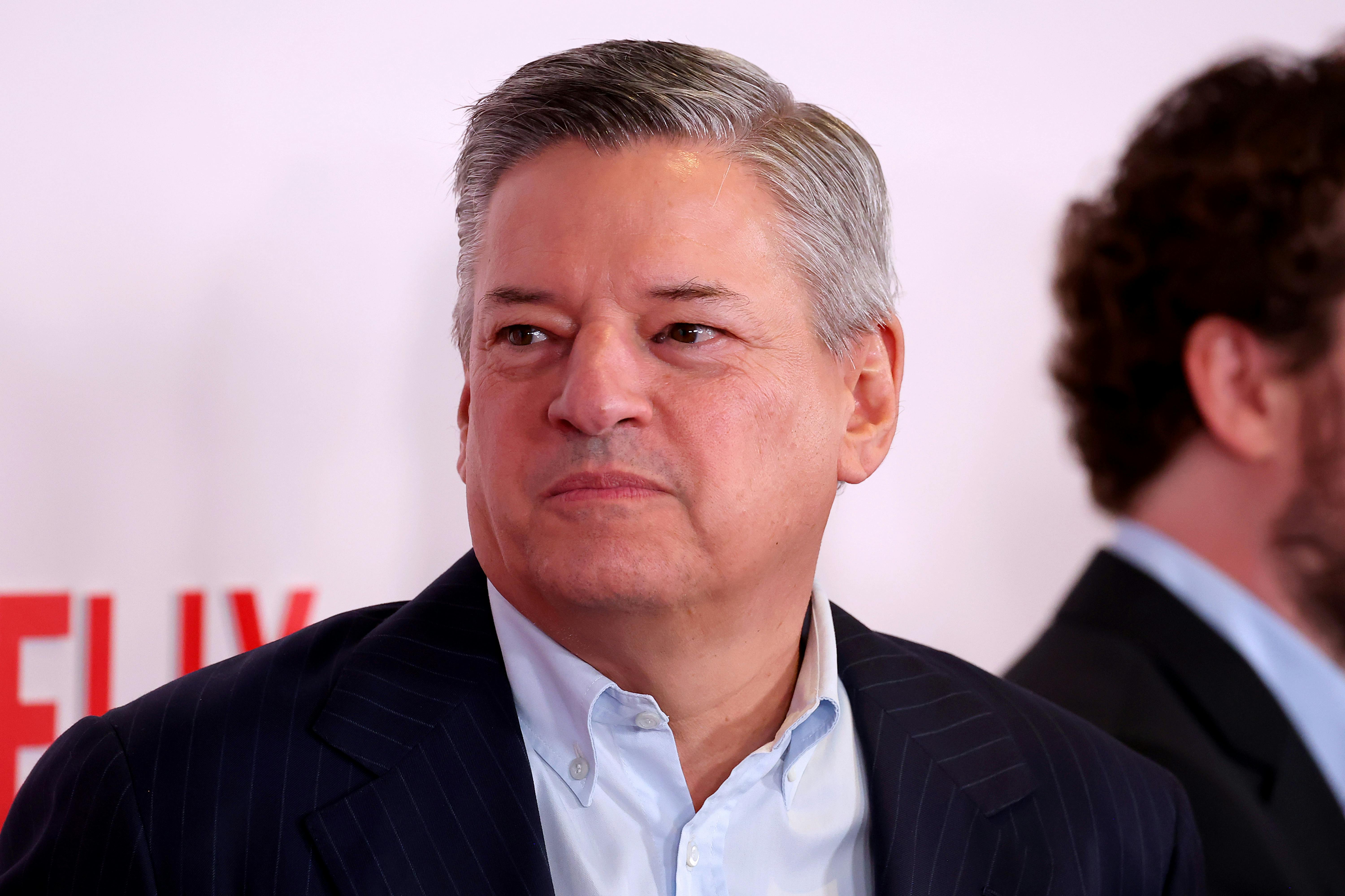 Ted Sarandos stands in front of a Netflix backdrop.