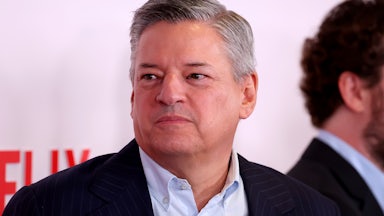 Ted Sarandos stands in front of a Netflix backdrop.