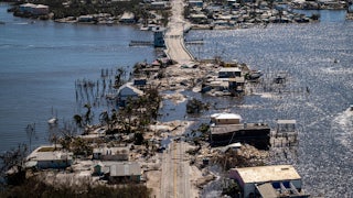 A road and neighborhood appear to sink into the sea in an image taken after Hurricane Ian.