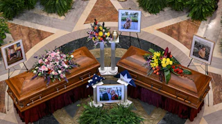 Melissa and Mark Hortman and their dog Gilbert lie in state in the Minnesota state Capitol