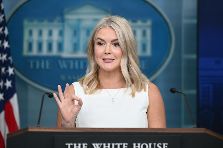 White House press secretary Karoline Leavitt makes an OK hand gesture at the podium in the press briefing room.