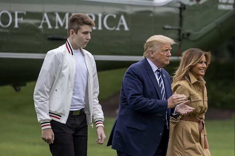 Barron, Donald, and Melania Trupm walk on the lawn