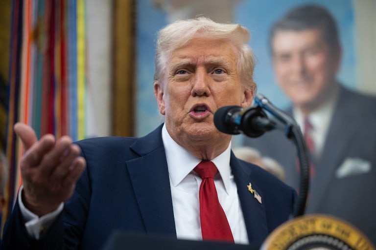 Donald Trump gestures while speaking at a podium
