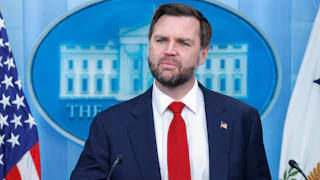 JD Vance stands at the podium in the White House Press Briefing Room.