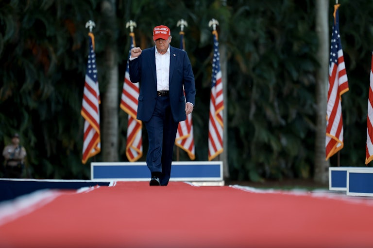 Donald Trump pumps his fist as he walks