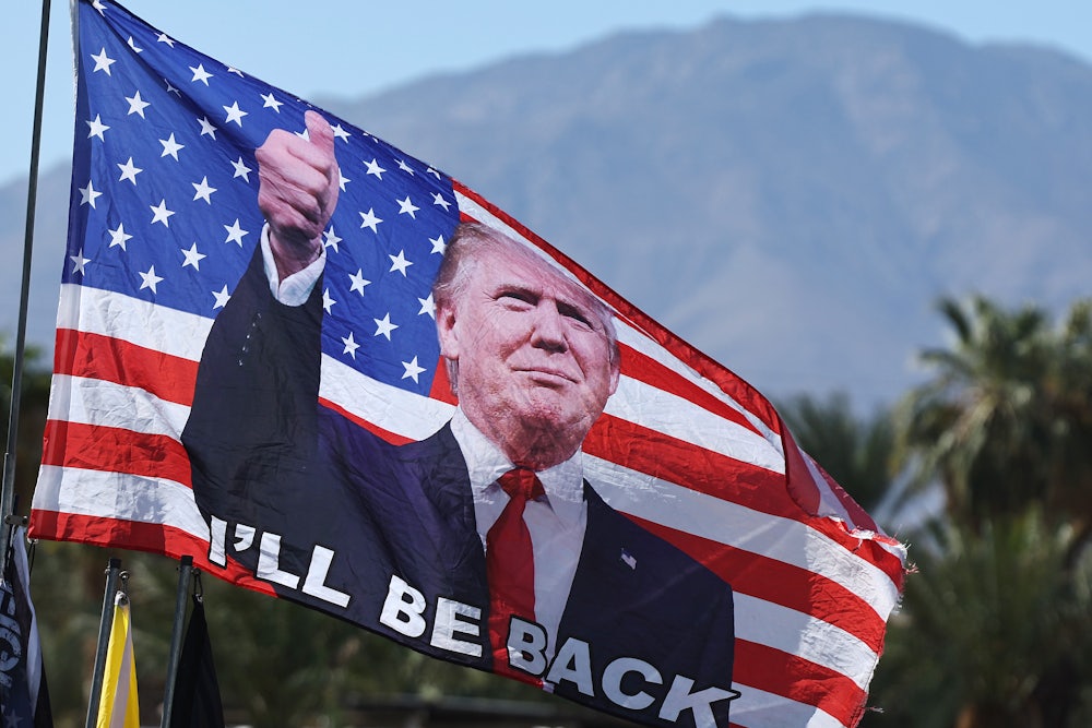 A Trump flag flies at a campaign rally for President Donald Trump in Coachella, California.