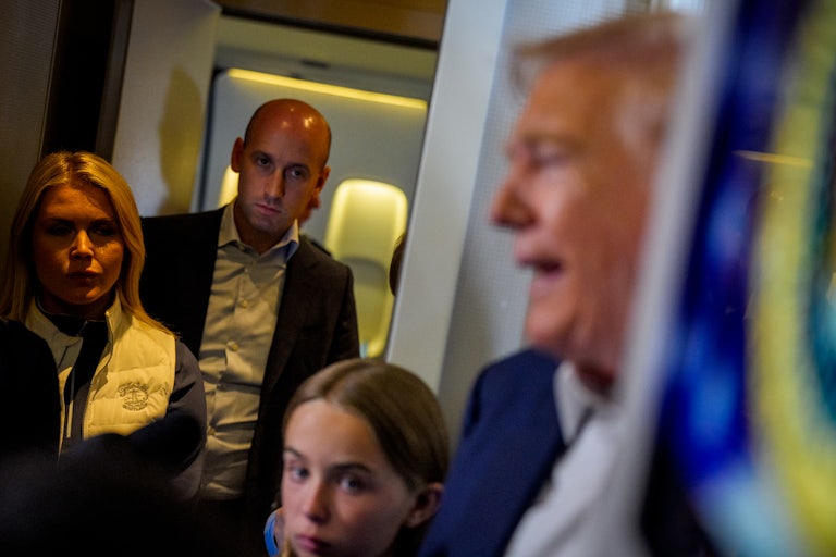 Stephen Miller stands on Air Force One as Donald Trump speaks to reporters