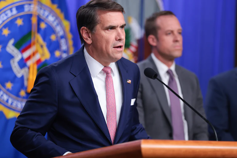 Acting Attorney General Todd Blanche speaks at a podium