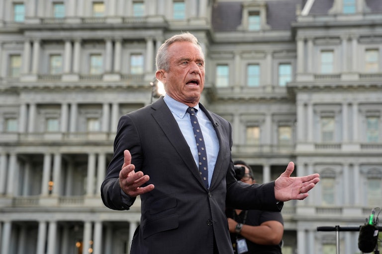 Robert F. Kennedy Jr. gestures while speaking outside to reporters