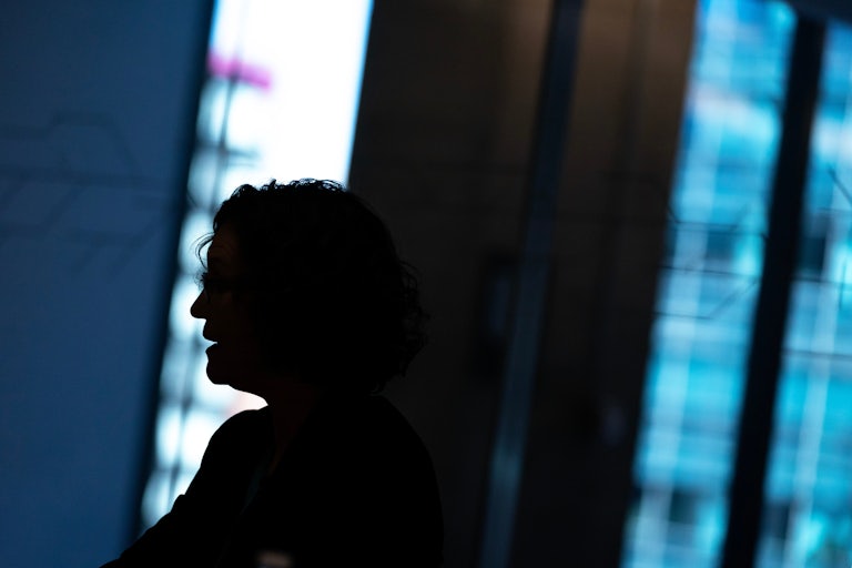 Silhoutte of someone standing in the gap of a doorway with their mouth open