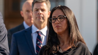 Representative Lauren Boebert stands outside during a press briefing.