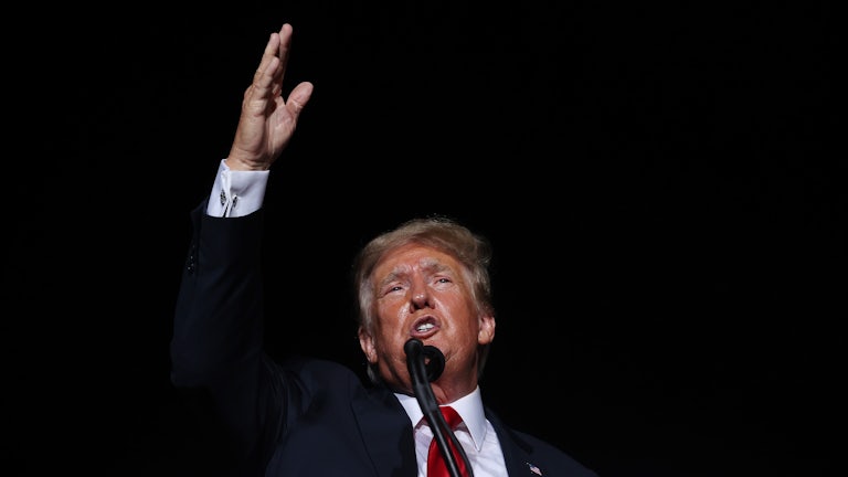 Former President Donald Trump waves at a rally.
