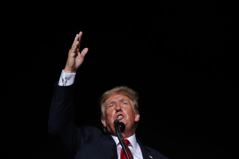 Former President Donald Trump waves at a rally.