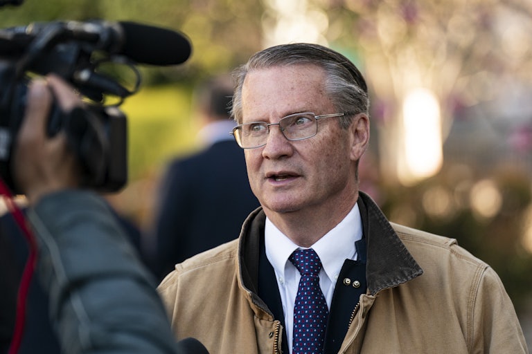 Representative Tim Burchett speaks outside as a video camera films him.
