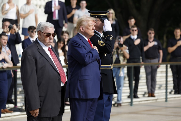 Trump, Bill Barnett, and another military official stand side by side at Arlington National Cemetery.