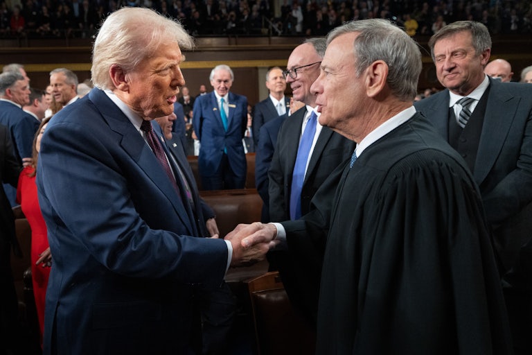 Donald Trump greets Chief Justice John Roberts as he arrives to deliver an address to a joint session of Congress.