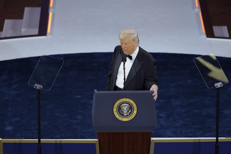 Donald Trump stands at a podium onstage