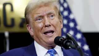 Donald Trump speaks into a microphone