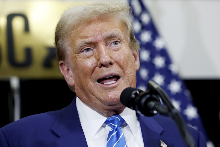 Donald Trump speaks into a microphone