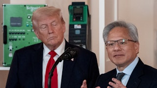 Donald Trump watches as Nvidia CEO Jensen Huang gestures and speaks at a podium