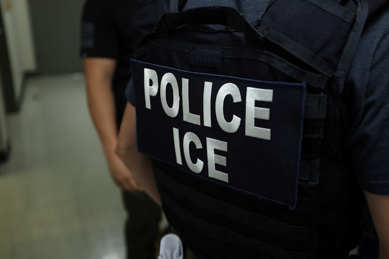 An ICE officer wears a tactical vest