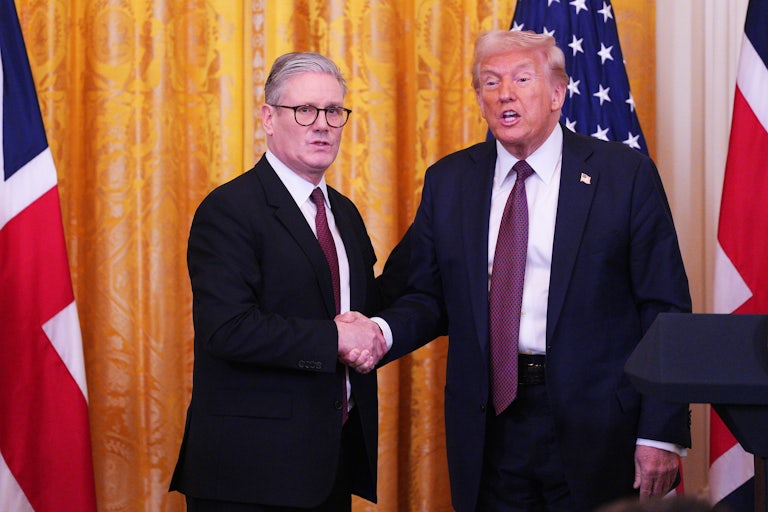 U.K. Prime Minister Keir Starmer shakes hands at the end of a press conference with Donald Trump, who speaks to reporters
