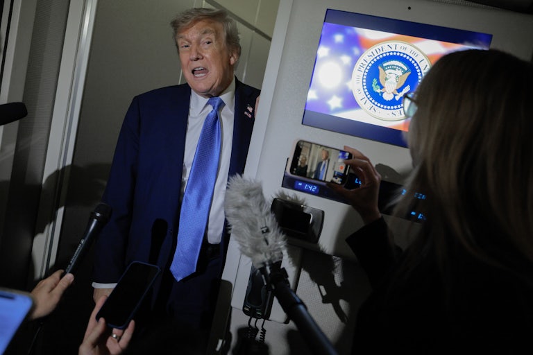 Donald Trump speaks to reporters on Air Force One