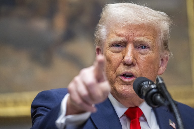 Donald Trump points as he speaks at a press conference.