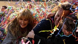 Confetti falling over the faces of Laura Dern, Will Arnett, and Calvin Knegten in Bradley Cooper’s “Is This Thing On?”