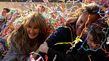 Confetti falling over the faces of Laura Dern, Will Arnett, and Calvin Knegten in Bradley Cooper’s “Is This Thing On?”
