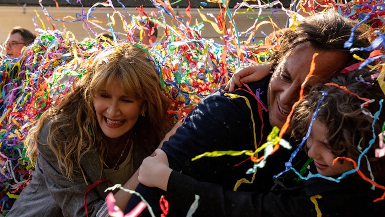 Confetti falling over the faces of Laura Dern, Will Arnett, and Calvin Knegten in Bradley Cooper’s “Is This Thing On?”