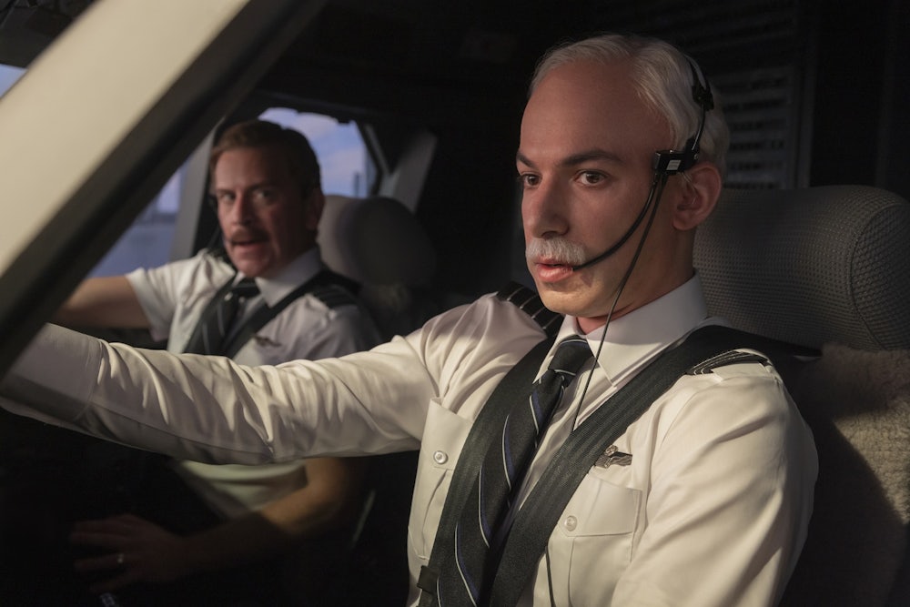 Nathan Fielder dressed as the pilot Chesley Sullenberger in a replica of a jet's cockpit.
