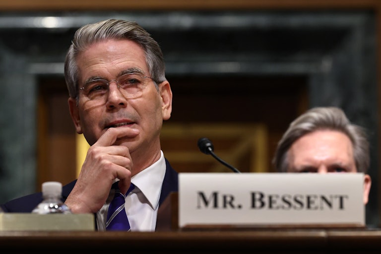 Scott Bessent puts a hand on his chin in his confirmation hearing