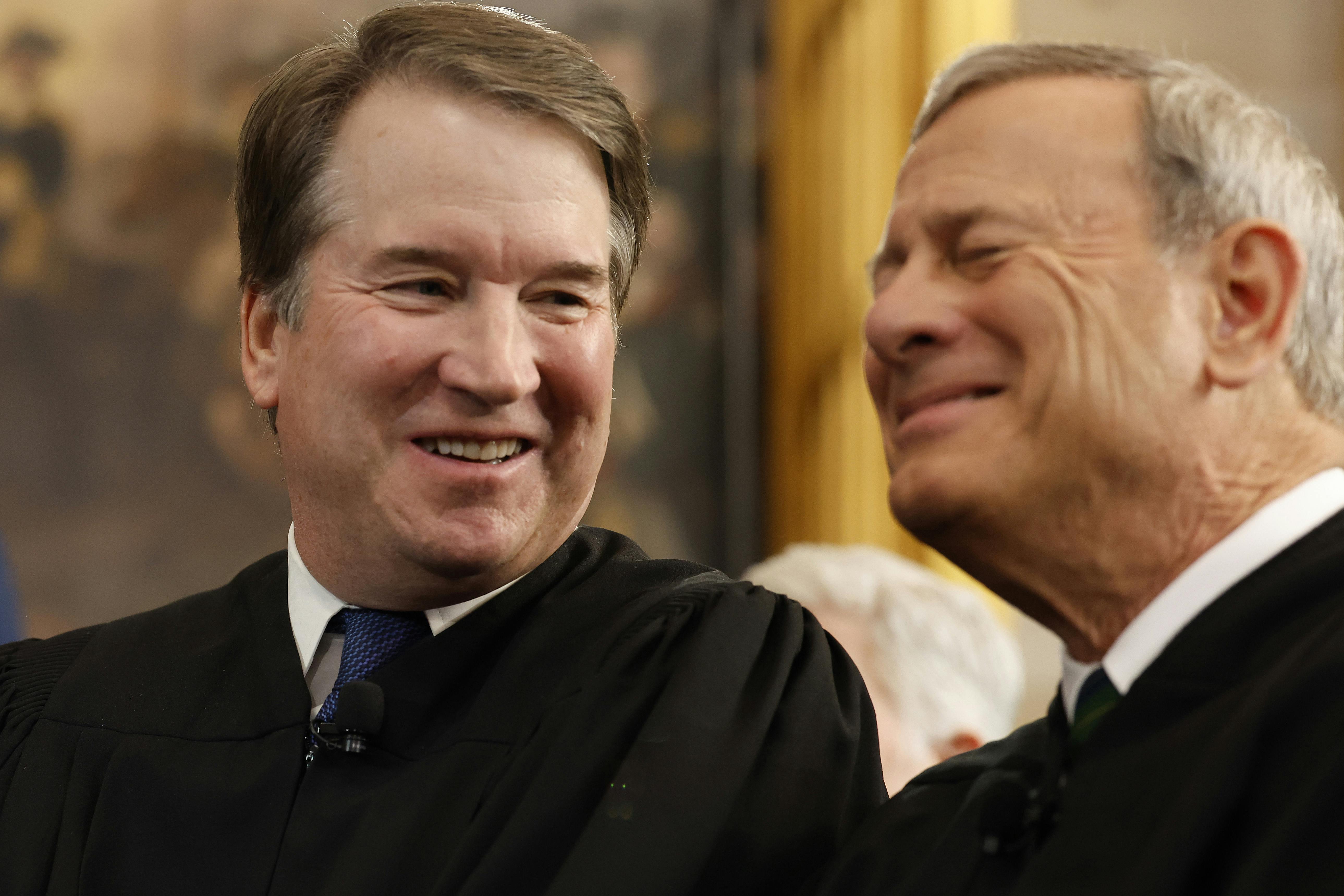 Supreme Court Associate Justice Brett Kavanaugh shares a laugh with Chief Justice John Roberts.