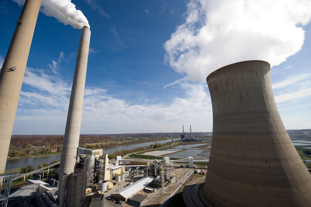 Cooling towers emit steam over an industrial landscape.