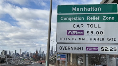Congestion Relief Zone toll sign on the westbound Long Island Expressway approaching Van Dam Street in Queens, New York.