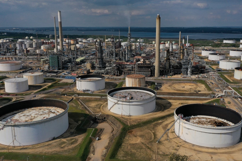 This photo shows smokestacks and industrial buildings near a body of water.