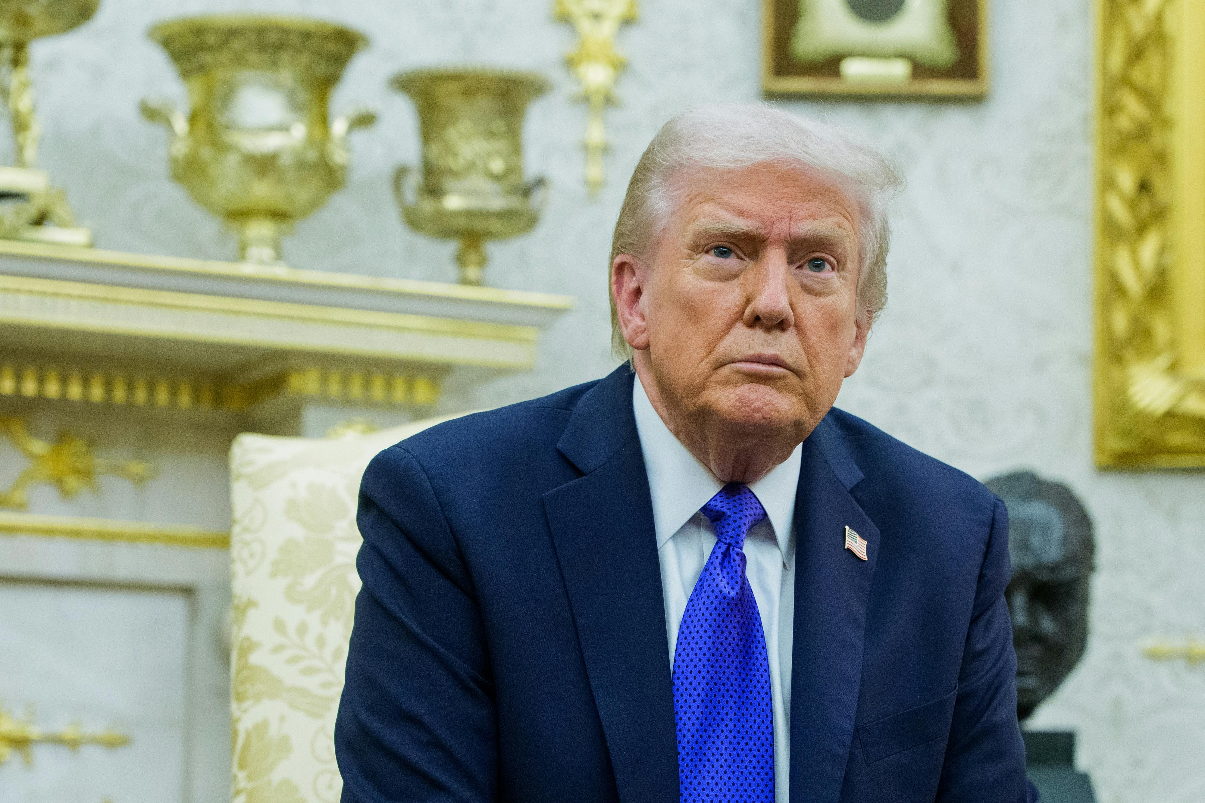 Donald Trump sits in his gold-filled Oval Office.