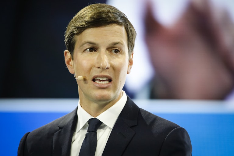 Jared Kushner wearing a presenter's microphone looks suprised