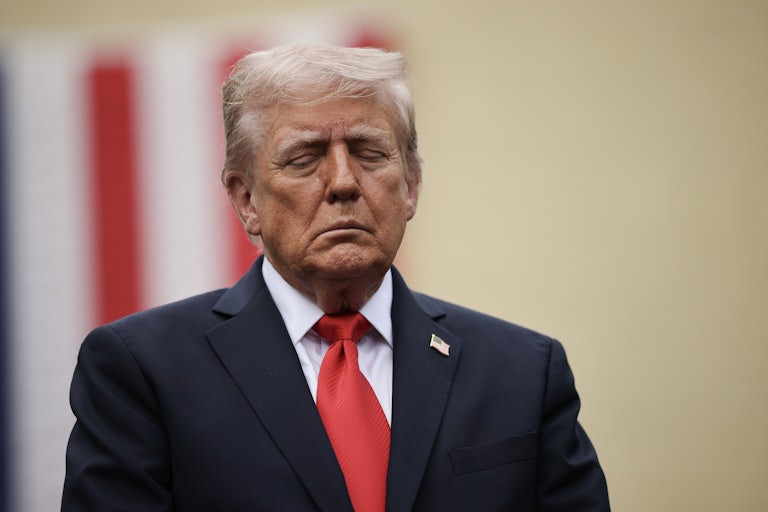 Donald Trump stands with his eyes closed