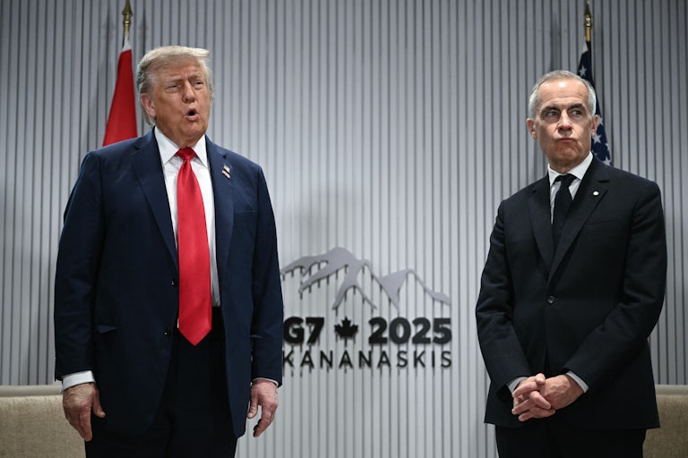 Donald Trump speaks while standing next to Canadian Prime Minister Mark Carney at the G7 meeting
