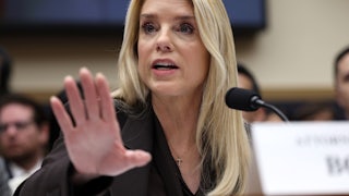 Attorney General holds out her hand while speaking during a House committee hearing