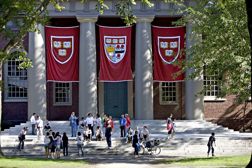 Harvard banners hang outside Memorial Church on the university campus.