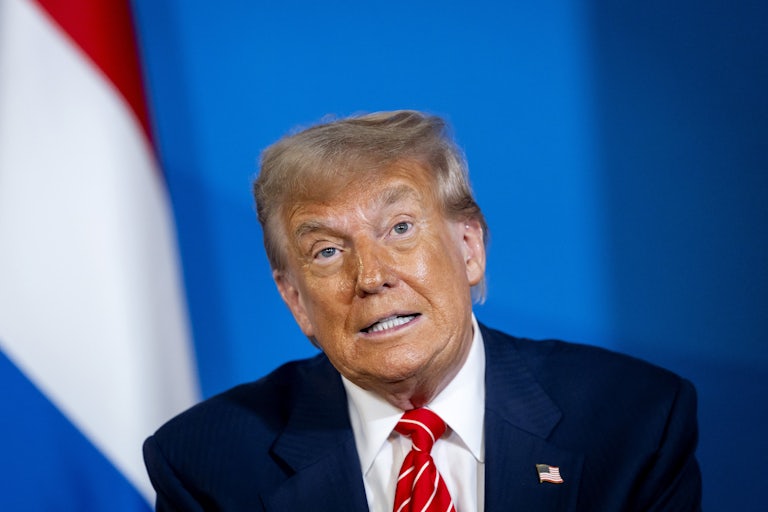 Donald Trump grimaces while speaking to reporters at the NATO summit at The Hague