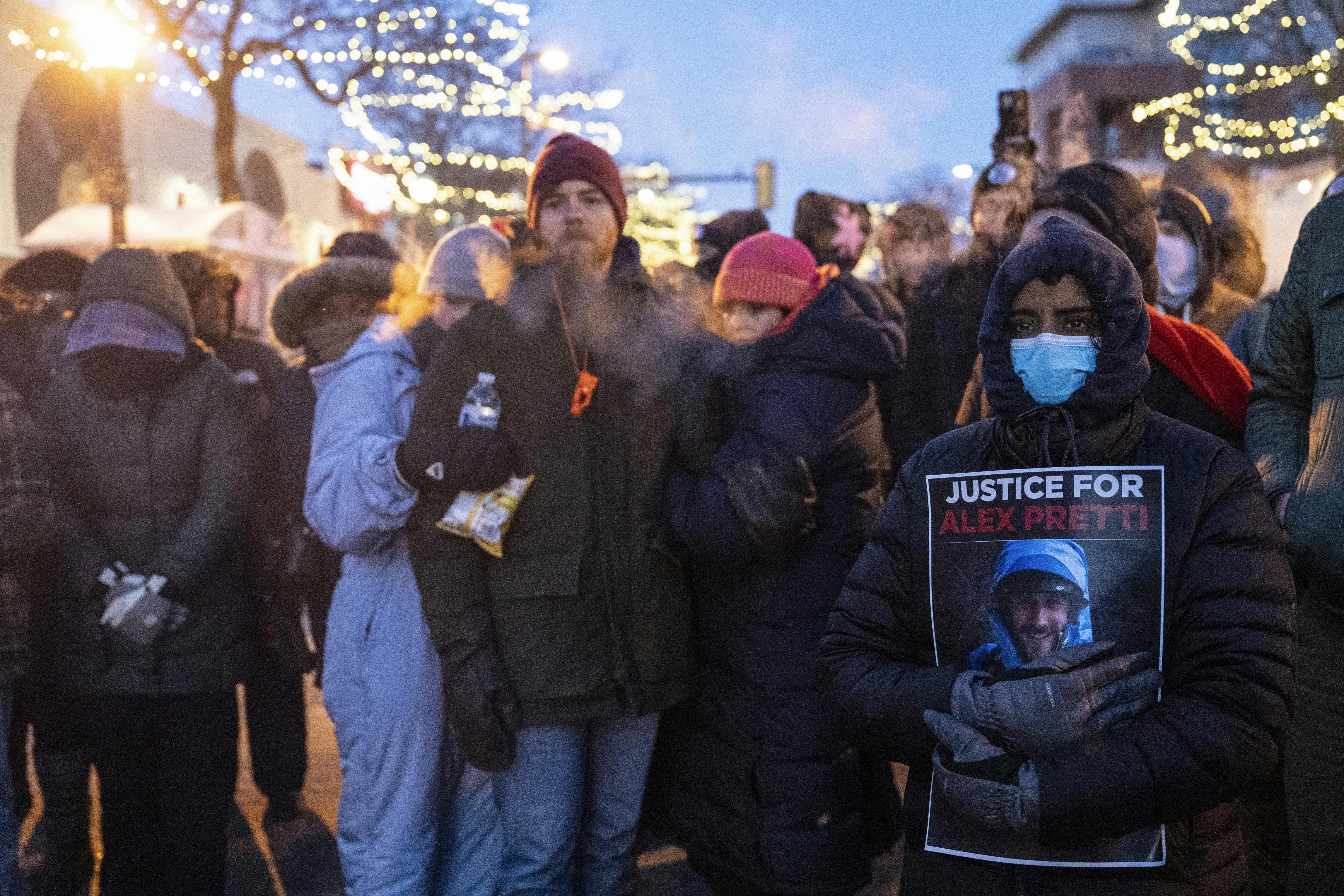 People stand at a memorial for Alex Pretti in Minneapolis, Minnesota