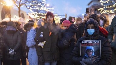 People stand at a memorial for Alex Pretti in Minneapolis, Minnesota